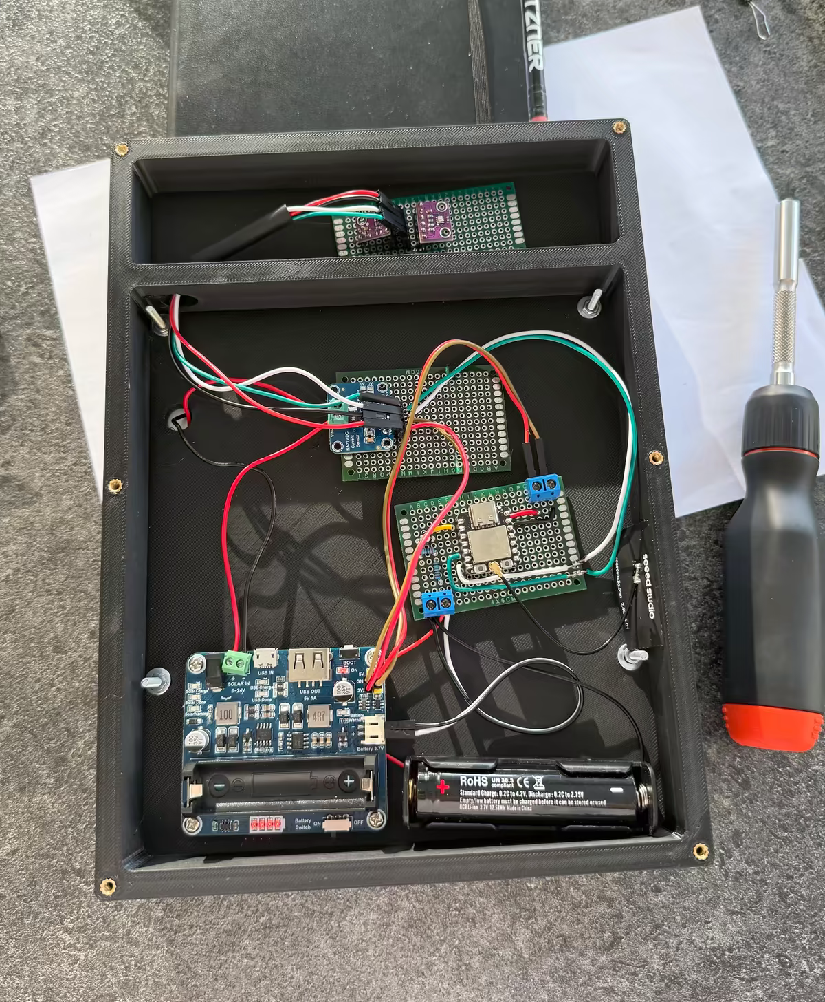Inside the station: the ESP32-C3, sensors, power management board, battery, and wiring